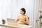 Selective focus of pregnant woman using laptop while working from home