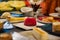 Selective focus on a raspberry ice cream on a plate at a table with varied desserts at a buffet