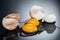 Selective focus of raw smashed chicken eggs with yolks, proteins and eggshell on black background.