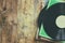 Selective focus of records stack with record on top over wooden table. vintage filtered