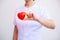 Selective focus of red smiling heart held by female nurse`s hand, representing giving effort high quality service mind to patient.