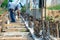 Selective focus on the reinforcement steel for concrete structure with blurred workers in background at construction site