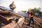 Selective focus Roofing tools, Roofer worker using a  electric drill install on new roof metal sheet at construction site