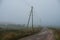 selective focus, rural winding road that goes into the misty distance a