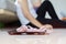 Selective focus at scale and measure tape, sad woman sitting on floor holding head and arms on knees