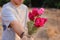 Selective focus and shallow depth of field of a beautiful bouquet of red roses are given with some person by young man. Love and r