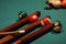 Selective focus shot of billiard balls and sticks on a green table