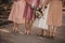 Selective focus shot of the bride and  bridesmaids holding bouquets of beautiful pink roses