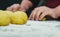 Selective focus shot of daugh balls on a heap of flour with chefs hand on the background