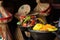 Selective focus shot of delicious Ethiopian food with fresh vegetables on a wooden table