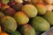 Selective focus shot of delicious mangos on a shelf for sale at a market