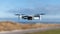 Selective focus shot of a flying drone - Mavic Mini, in the air near the beach on Kiel, Germany