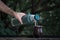 Selective focus shot of a hand pouring water from a thermos in  calabash mate cup with straw