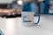 Selective focus shot of a mug with a printed text of CSS IS AWESOME with a blurred background