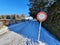 Selective focus shot of an old street stop sign on a snowy winter d