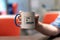 Selective focus shot of a person holding a mug with a printed text of CSS IS AWESOME