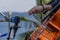 Selective focus shot of a person playing the cello in front of a microphone