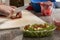 Selective focus shot of person slicing bacon preparing for a salad