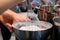 Selective focus shot of a person stirring cake batter in a bowl