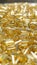 Selective focus shot of a pile of shiny golden glass beads