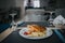 Selective focus shot of a plate of potato fries and sandwiches on a dining table