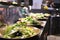 Selective focus shot of plates of fresh vegetable salad on the counter in a restaurant