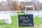 Selective focus shot of signage, pick a seat either side on a wedding day