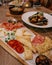 Selective focus shot of a variety of appetizers on a wooden board