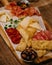 Selective focus shot of a variety of appetizers on a wooden board