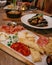 Selective focus shot of a variety of appetizers on a wooden board