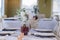 Selective focus shot of white roses in a transparent glass vase placed in a dining table