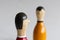 Selective focus shot of a wooden skittle with a face isolated on a white background