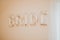 Selective focus shot of the word \\\'bride\\\' made of golden balloons on a wall