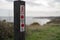 Selective focus of the sign with distances at the cliff walk trail in Ireland.