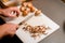 selective focus on sliced champignons and male hand chopping mushrooms with a knife