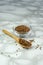 selective focus, small Chia seeds in a glass jar and with a wooden spoon