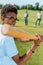 selective focus of smiling african american teenager playing baseball with friends