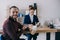 selective focus of smiling client with coffee to go pointing at businesswoman