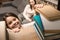 selective focus of smiling daughter taking book for reading from bookshelf