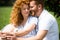 selective focus of smiling redhead couple sitting