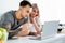 Selective focus of smiling tattooed couple using laptop during breakfast