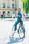 selective focus smiling young student with backpack on bicycle looking at camera