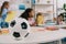 selective focus of soccer ball on table and multiracial preschoolers