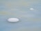 Selective focus. Spring ice, snowy round islands on melting ice. Abstract natural background