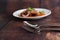 Selective focus stainless spoon and fork on wooden table