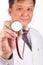 Selective focus on stethoscope held by Asian male medical doctor