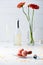 selective focus of sweet macarons, bottle and glass of champagne, bouquet of gerbera flowers