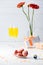 selective focus of sweet macarons, flowers in vase, gifts and glasses of yellow champagne