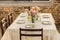 selective focus of table served with wine glasses, empty plates and bottle of wine