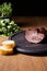Selective focus of tasty ham on board near parsley and baguette on wooden table